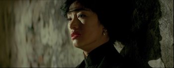 Movie still from “2046” (2004), directed by Kar-Wai Wong – A person with a black shirt and red lipstick; Close Up shot, Low angle