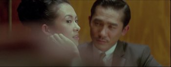 Movie still from “2046” (2004), directed by Kar-Wai Wong – A man and a woman are looking at each other; Close Up shot, Over the shoulder angle