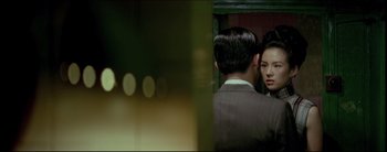 Movie still from “2046” (2004), directed by Kar-Wai Wong – A man and a woman looking at each other in a mirror; Medium shot, Over the shoulder angle
