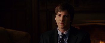 Movie still from “21” (2008), directed by Robert Luketic – A man in a suit and tie in a dark room; Close Up shot, Over the shoulder angle