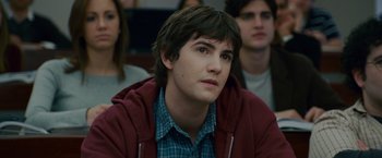 Movie still from “21” (2008), directed by Robert Luketic – A young man sitting in front of a group of people; Close Up shot, Over the shoulder angle