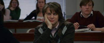 Movie still from “21” (2008), directed by Robert Luketic – A woman sitting in a class room with her head resting on her hand; Close Up shot, Over the shoulder angle