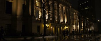 Movie still from “21” (2008), directed by Robert Luketic – Two people walking on the sidewalk in front of a building at night; Extreme Wide shot, Low angle