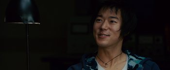 Movie still from “21” (2008), directed by Robert Luketic – A young man with a smile on his face; Close Up shot, Over the shoulder angle