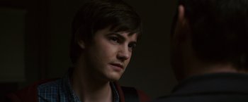 Movie still from “21” (2008), directed by Robert Luketic – A young man looking into the distance while standing next to another man; Close Up shot, Over the shoulder angle