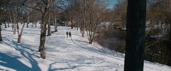 Movie still from “21” (2008), directed by Robert Luketic – Two people are walking in the snow near a river; Extreme Wide shot, High angle