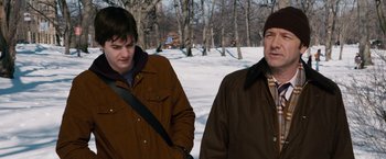 Movie still from “21” (2008), directed by Robert Luketic – Two men standing next to each other in the snow; Medium shot, Over the shoulder angle