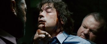 Movie still from “21” (2008), directed by Robert Luketic – A man with blood all over his face and neck; Close Up shot, Overhead angle