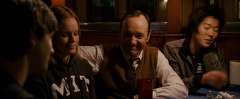 Movie still from “21” (2008), directed by Robert Luketic – A man sitting next to a woman at a table; Medium shot, Over the shoulder angle