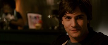 Movie still from “21” (2008), directed by Robert Luketic – A young man's face in a dark room; Close Up shot, Over the shoulder angle