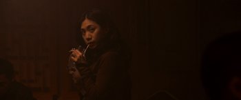 Movie still from “21” (2008), directed by Robert Luketic – A woman holding a drink and smoking a cigarette; Medium shot, Low angle