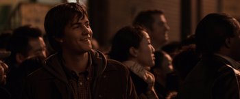 Movie still from “21” (2008), directed by Robert Luketic – A group of people standing next to each other in a room; Close Up shot, Over the shoulder angle