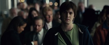 Movie still from “21” (2008), directed by Robert Luketic – A young man standing in front of a group of people; Medium shot, Over the shoulder angle
