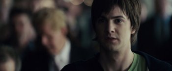 Movie still from “21” (2008), directed by Robert Luketic – A young man is looking into the camera; Close Up shot, Over the shoulder angle