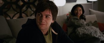 Movie still from “21” (2008), directed by Robert Luketic – A young man sitting on a couch looking at the camera; Close Up shot, Over the shoulder angle