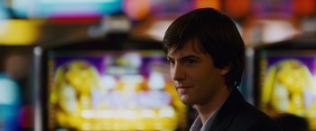 Movie still from “21” (2008), directed by Robert Luketic – A young man is standing in front of some lights; Close Up shot, Over the shoulder angle