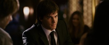 Movie still from “21” (2008), directed by Robert Luketic – A man in a black suit and white tie; Close Up shot, Over the shoulder angle