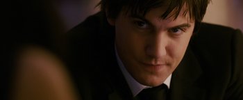 Movie still from “21” (2008), directed by Robert Luketic – A person wearing a suit and tie; Close Up shot, Over the shoulder angle