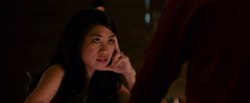 Movie still from “21” (2008), directed by Robert Luketic – A beautiful young lady sitting at a table talking on a cell phone; Close Up shot, Over the shoulder angle