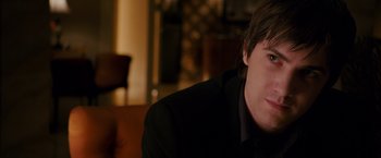 Movie still from “21” (2008), directed by Robert Luketic – A person wearing a suit and tie; Close Up shot, Over the shoulder angle