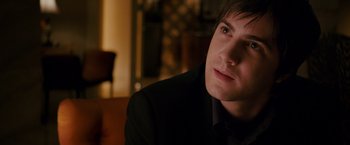 Movie still from “21” (2008), directed by Robert Luketic – A person wearing a suit and tie; Close Up shot, Over the shoulder angle