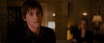 Movie still from “21” (2008), directed by Robert Luketic – A man in a black shirt and a black jacket; Close Up shot, Over the shoulder angle