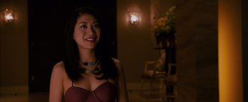Movie still from “21” (2008), directed by Robert Luketic – A beautiful young lady standing in front of a lamp; Close Up shot, Over the shoulder angle