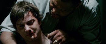 Movie still from “21” (2008), directed by Robert Luketic – A man is getting his face painted by a man with a knife; Close Up shot, Over the shoulder angle