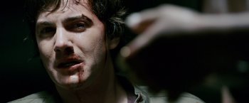 Movie still from “21” (2008), directed by Robert Luketic – A man's face with blood on his face; Close Up shot, Overhead angle
