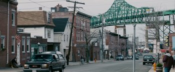 Movie still from “21” (2008), directed by Robert Luketic – Two people riding a bike down a street; Extreme Wide shot, High angle