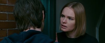 Movie still from “21” (2008), directed by Robert Luketic – A woman looking in the mirror with her hand on her face; Close Up shot, Over the shoulder angle
