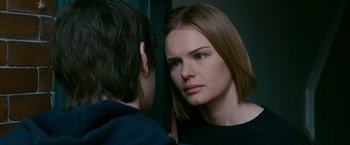 Movie still from “21” (2008), directed by Robert Luketic – A woman looking into a mirror while standing next to a boy; Close Up shot, Over the shoulder angle