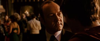 Movie still from “21” (2008), directed by Robert Luketic – A man in a suit and tie looking to his left; Close Up shot, Over the shoulder angle