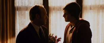 Movie still from “21” (2008), directed by Robert Luketic – Two men talking to each other in front of a window; Close Up shot, Over the shoulder angle