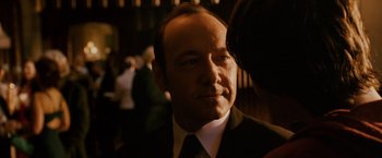 Movie still from “21” (2008), directed by Robert Luketic – A man in a suit and tie looking at the camera; Close Up shot, Over the shoulder angle