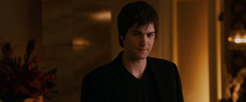 Movie still from “21” (2008), directed by Robert Luketic – A man in a black jacket is looking at the camera; Close Up shot, Over the shoulder angle