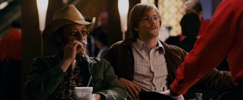 Movie still from “21” (2008), directed by Robert Luketic – Two men sitting next to each other at a table; Medium shot, Over the shoulder angle