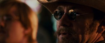 Movie still from “21” (2008), directed by Robert Luketic – A person wearing a hat and sunglasses; Close Up shot, Over the shoulder angle