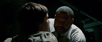 Movie still from “21” (2008), directed by Robert Luketic – A man in a tie is talking to another man in a suit; Close Up shot, Over the shoulder angle