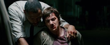 Movie still from “21” (2008), directed by Robert Luketic – A man holding a knife over another man's face; Close Up shot, High angle