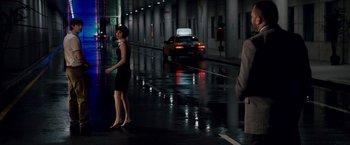 Movie still from “21” (2008), directed by Robert Luketic – A woman in a black dress walking down a wet street; Wide shot, Over the shoulder angle