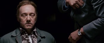 Movie still from “21” (2008), directed by Robert Luketic – A man with his eyes closed is being photographed; Close Up shot, Low angle