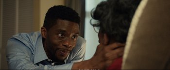 Movie still from “21 Bridges” (2019), directed by Brian Kirk – A man and a woman are talking to each other; Close Up shot, Over the shoulder angle