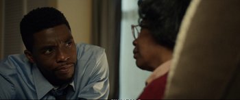 Movie still from “21 Bridges” (2019), directed by Brian Kirk – A man and a woman talking to each other; Close Up shot, Over the shoulder angle