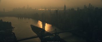 Movie still from “21 Bridges” (2019), directed by Brian Kirk – A view of a bridge and a city at sunset; Extreme Wide shot, High angle