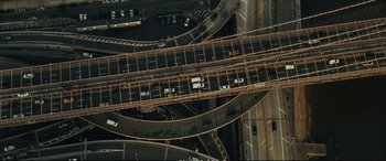 Movie still from “21 Bridges” (2019), directed by Brian Kirk – An aerial view of a busy city street with many cars; Extreme Wide shot, Overhead angle