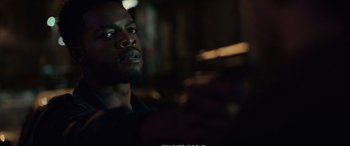 Movie still from “21 Bridges” (2019), directed by Brian Kirk – A person looking at the camera; Close Up shot, Over the shoulder angle