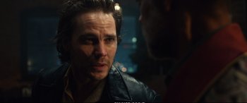 Movie still from “21 Bridges” (2019), directed by Brian Kirk – A person wearing a leather jacket; Close Up shot, Over the shoulder angle