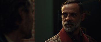 Movie still from “21 Bridges” (2019), directed by Brian Kirk – A person with a beard; Close Up shot, Over the shoulder angle