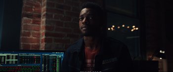 Movie still from “21 Bridges” (2019), directed by Brian Kirk – A man in a black jacket is looking at the camera; Close Up shot, Over the shoulder angle